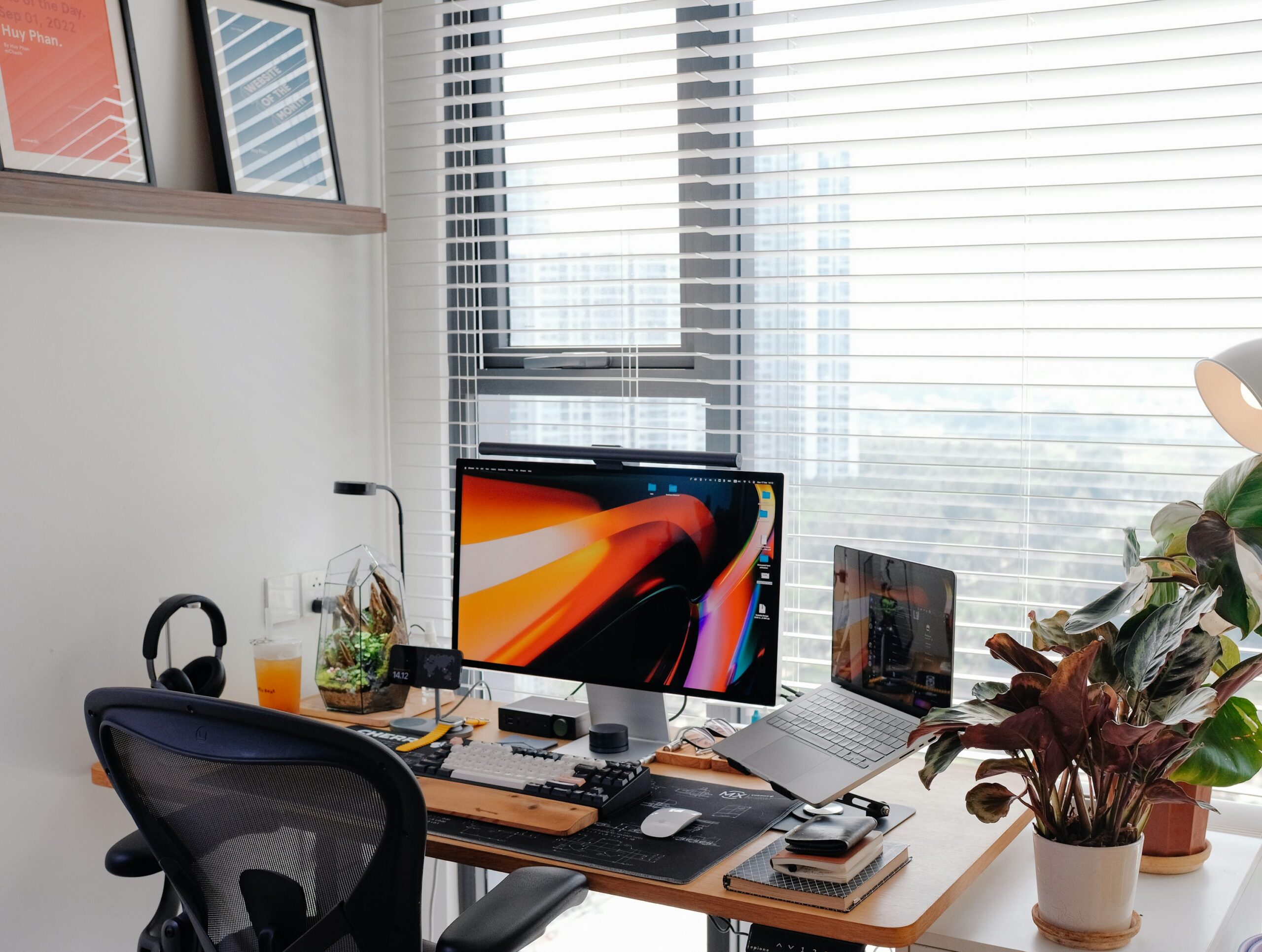 Organized home office desk with a raised laptop and external keyboard