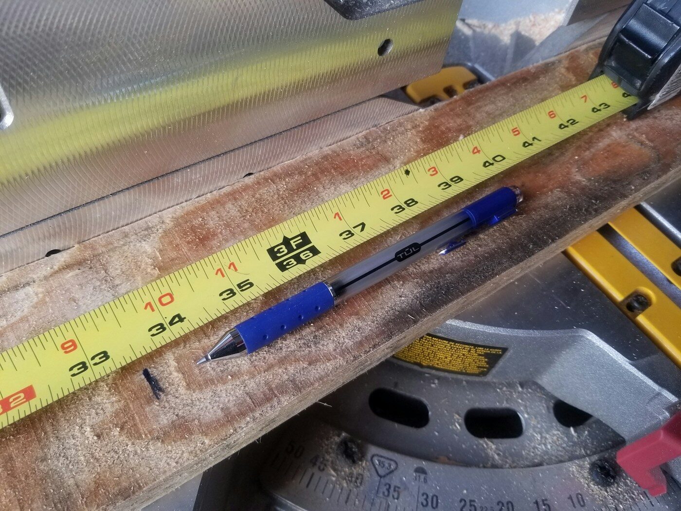 measuring tape on a work surface for planning drill driver placement and simple home repairs