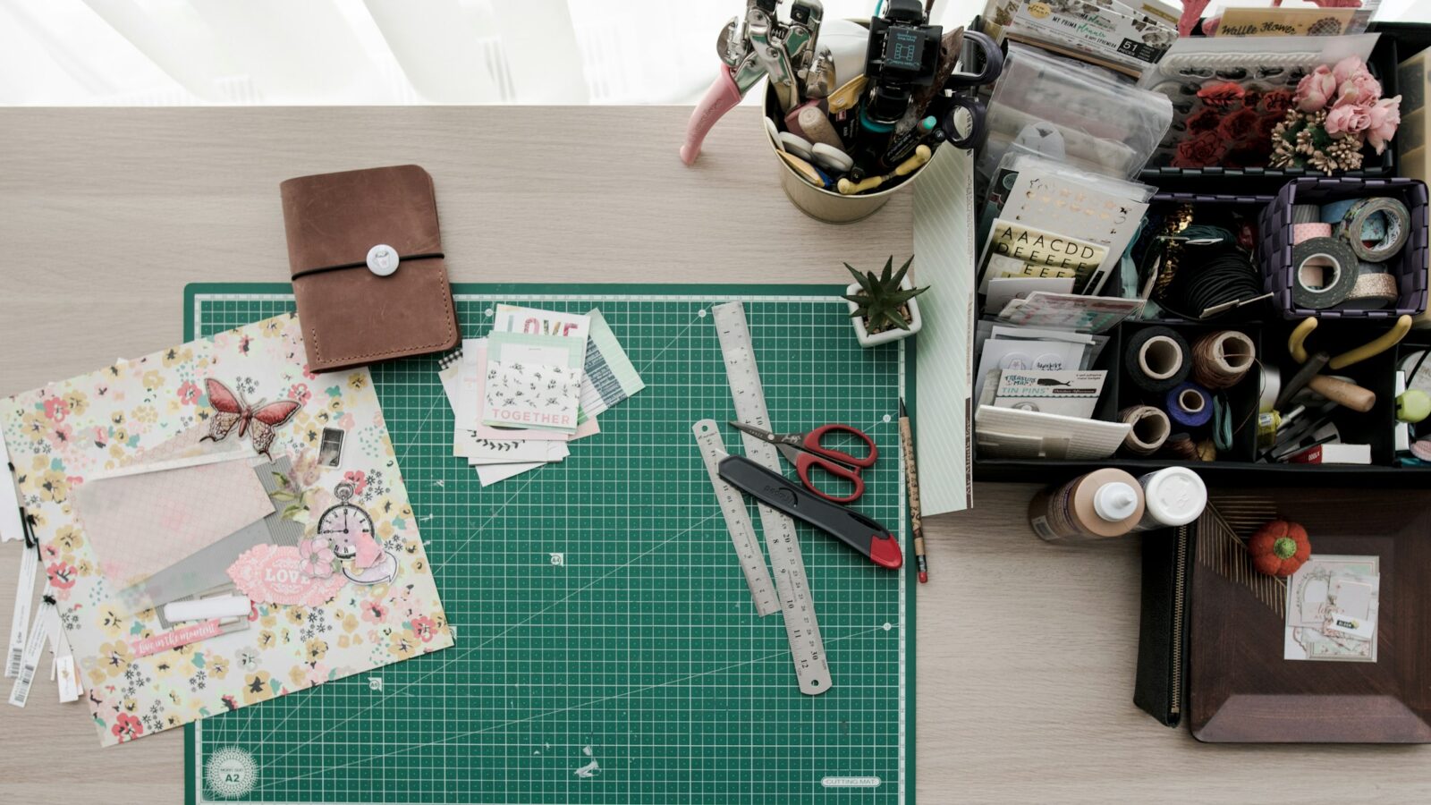 Paper craft workspace for comparing home laminators in Canada